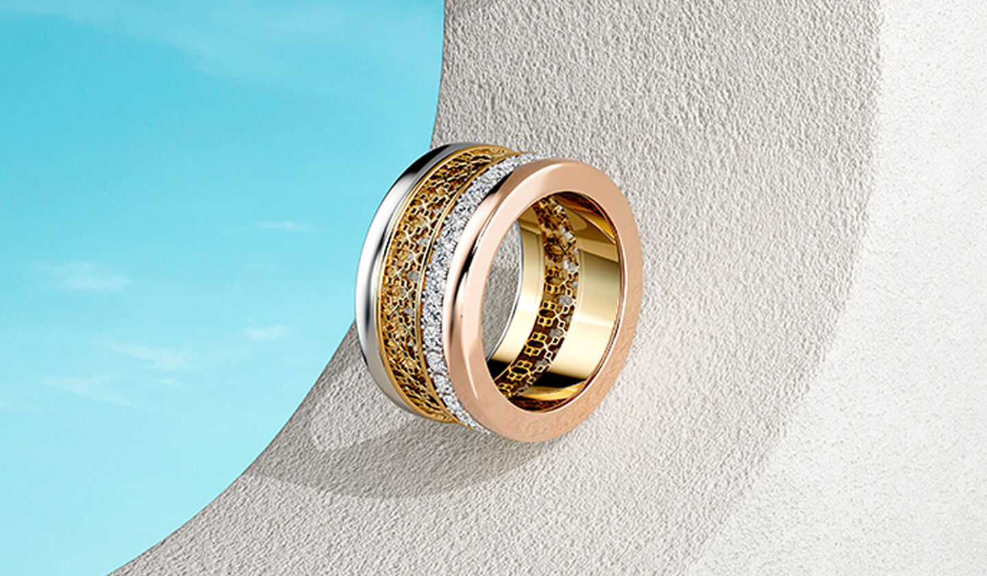 A Birks Dare to Dream tri-gold ring on a blue background.